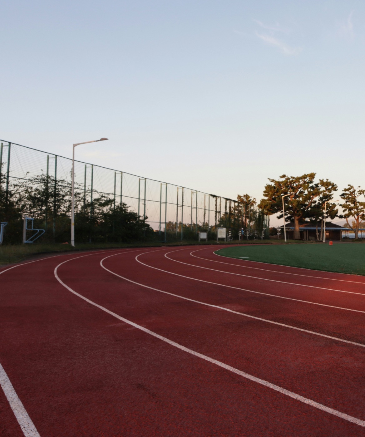 An empty running track at golden hour